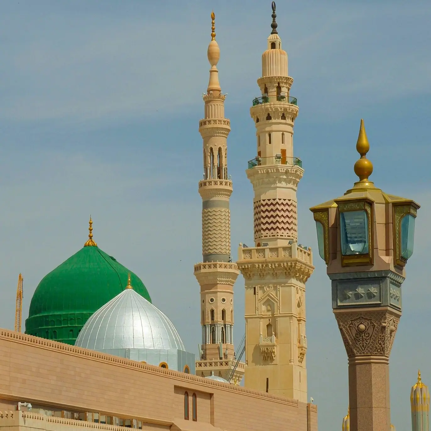 a large building with a green dome and a clock tower